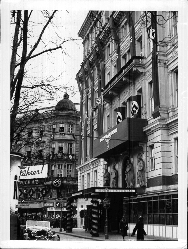 Adolf Hitler salutes from the balcony of the Hotel Imperial in Vienna
